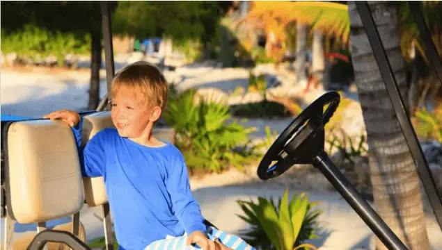 child in golf cart