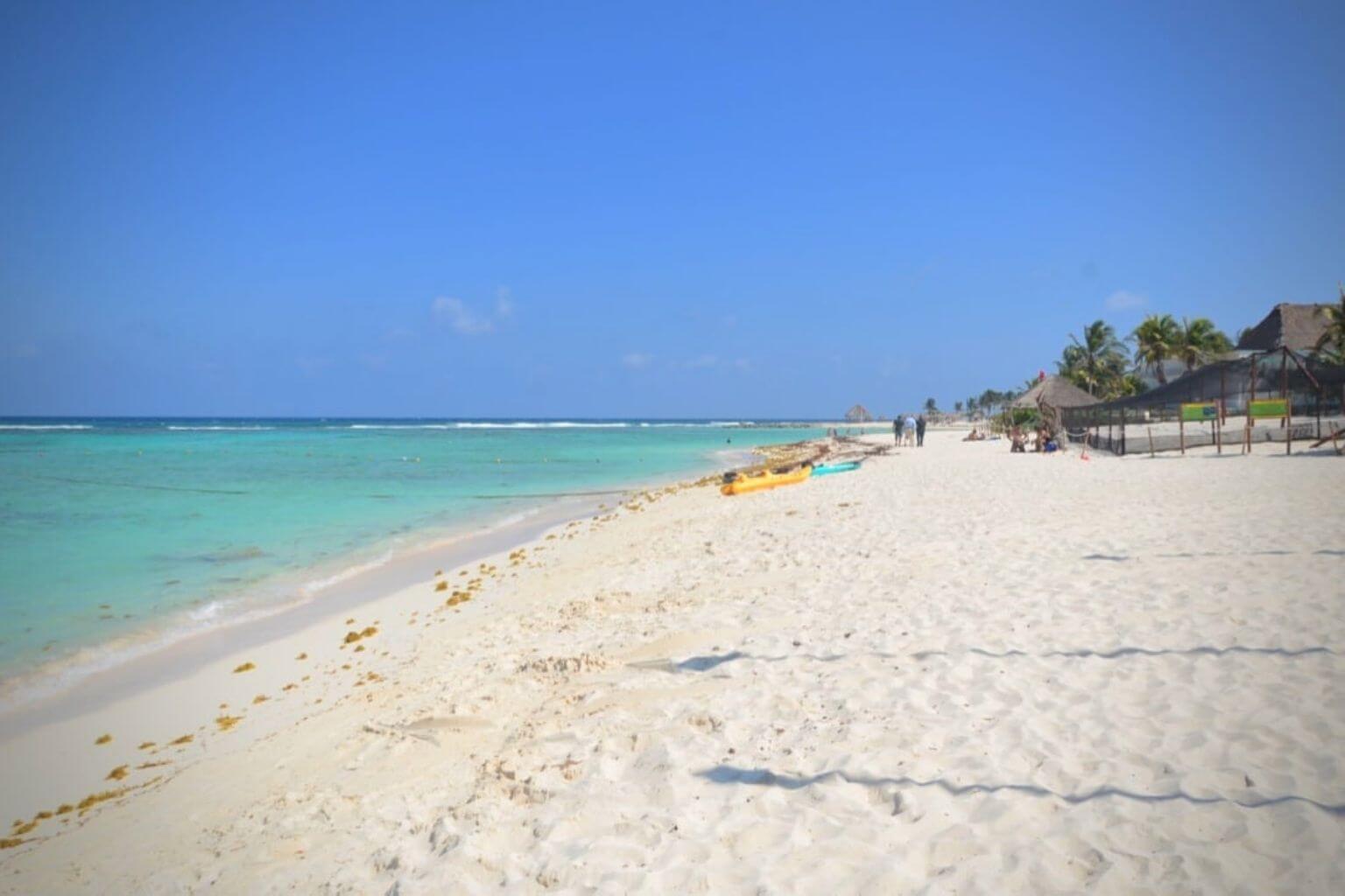 The sandy beach and flat ocean at Kay Beach Club