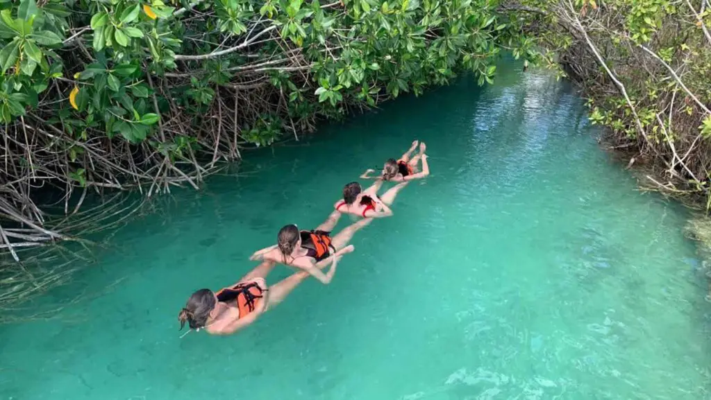 A group of girls floating through the mangroves canals in Muyil.