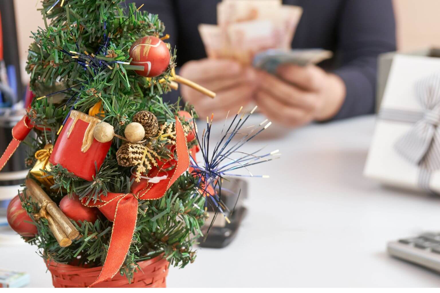 Christmas tree with man counting money in background