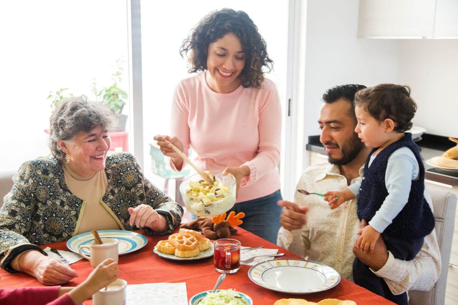 Mexican family serving holiday dinner