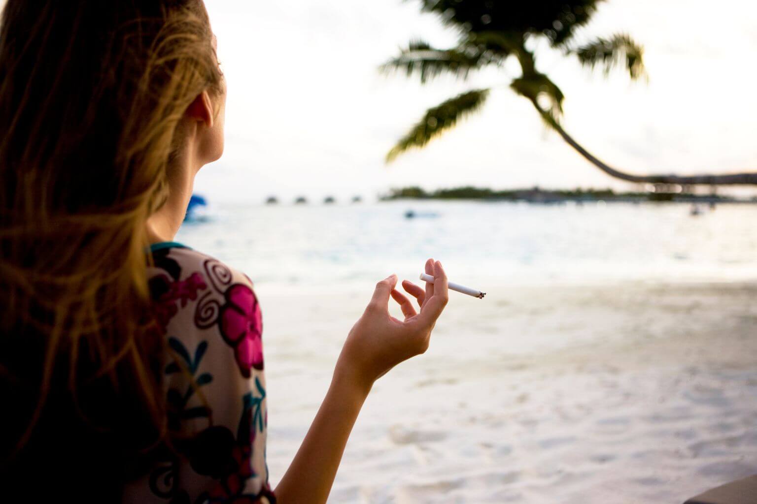 Woman smoking at the beach in Mexico