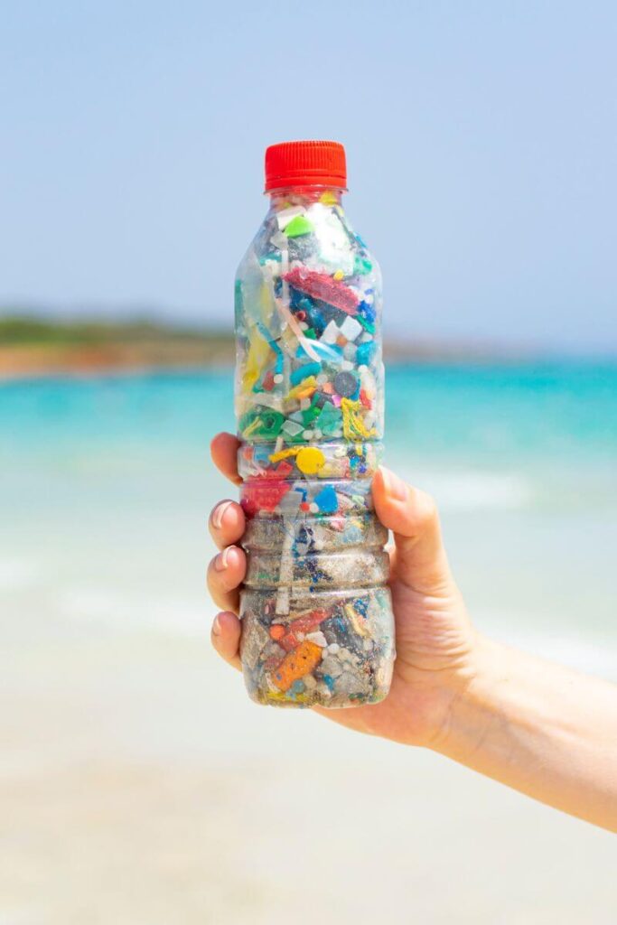 A plastic bottle filled with small plastic particles collected from a beach. This can help in saving the mesoamerican reef